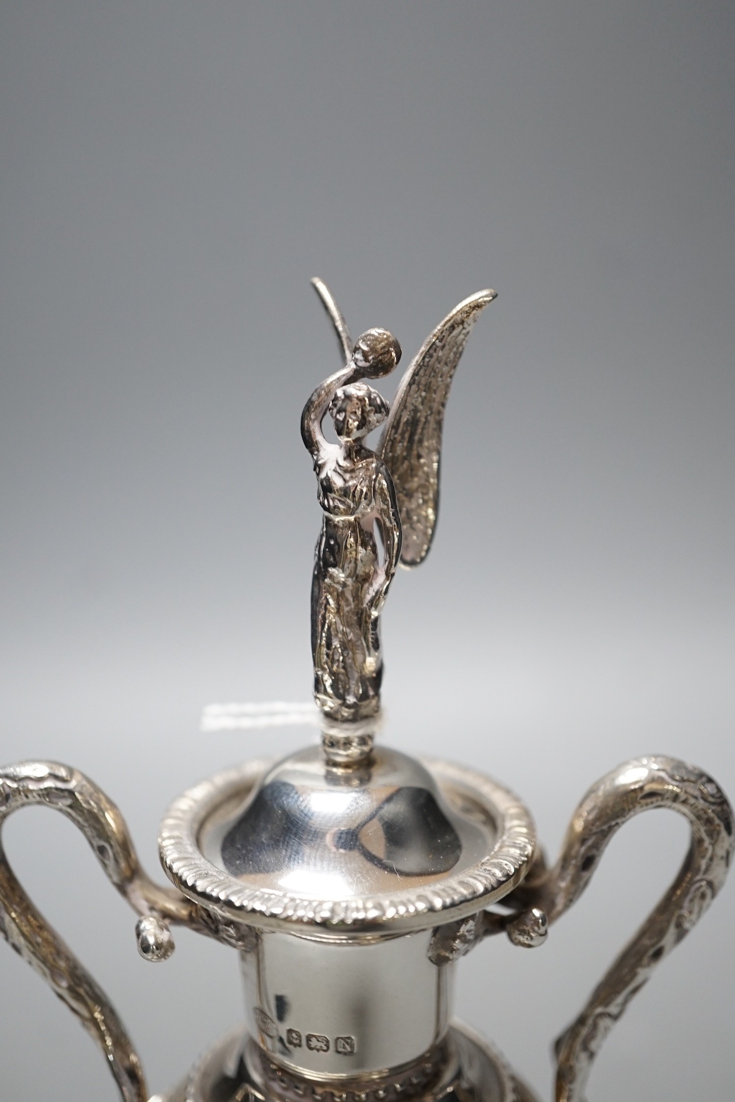 A George VI silver two handled golfing related presentation trophy cup and cover, Alexander Clark Co. Ltd, Birmingham, 1937, 18.3cm, 4.9oz, on wooden socle.